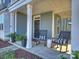 Front porch with rocking chairs and potted plants at 7027 Walnut Branch Ln, Charlotte, NC 28277