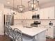 Open concept kitchen with white cabinets and large island at 7027 Walnut Branch Ln, Charlotte, NC 28277