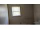 Small bedroom with wood paneling and window at 835 Maple Ave, Salisbury, NC 28144