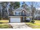 Charming two-story home with a brick facade, an attached garage, and a well-manicured lawn at 10307 Taftnale Ct, Charlotte, NC 28214