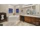 Bathroom with corner tub, wood vanity, and walk-in shower at 1055 Cedar Hills Ln, Lancaster, SC 29720