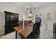 Formal dining room featuring a dark wood table and black china cabinet at 1055 Cedar Hills Ln, Lancaster, SC 29720