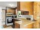 Galley kitchen with wood cabinets and electric stove at 12016 Ramah Church Rd, Huntersville, NC 28078