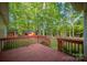 A stained wood back deck and stairs lead to the lovely backyard and shed at 1313 Western Hills Ln, Vale, NC 28168