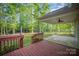 Relax on the stained wood back deck and covered porch, overlooking the backyard at 1313 Western Hills Ln, Vale, NC 28168