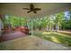 A covered back porch featuring fan and wooded view at 1313 Western Hills Ln, Vale, NC 28168