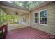 A covered back porch with access to a well-maintained yard and home access at 1313 Western Hills Ln, Vale, NC 28168