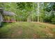 Expansive backyard with mature trees and landscaping at 1313 Western Hills Ln, Vale, NC 28168