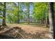 Spacious backyard surrounded by mature trees, featuring an inviting outdoor space with natural landscaping at 1313 Western Hills Ln, Vale, NC 28168