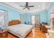 Light blue bedroom with hardwood floors and ceiling fan at 1313 Western Hills Ln, Vale, NC 28168