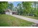 Two car garage, complemented by well-manicured lawns and a long driveway leading to the home at 1313 Western Hills Ln, Vale, NC 28168