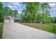 Long driveway leading to a charming home with a two-car garage, complemented by well-manicured lawns at 1313 Western Hills Ln, Vale, NC 28168