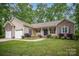 Charming single-story home with a brick-accented facade, attached two-car garage, and well-manicured lawn at 1313 Western Hills Ln, Vale, NC 28168