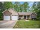 Charming single-story home with a brick-accented facade, attached two-car garage, and well-manicured lawn at 1313 Western Hills Ln, Vale, NC 28168