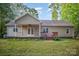 Exterior view of the home with a covered porch, stained wood back deck, and lush lawn at 1313 Western Hills Ln, Vale, NC 28168