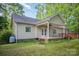 A great view of the home's exterior, back deck, covered porch, and lush lawn at 1313 Western Hills Ln, Vale, NC 28168