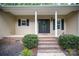 Inviting covered front porch with columns and a black front door at 1313 Western Hills Ln, Vale, NC 28168