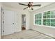 Carpeted bedroom featuring a ceiling fan and an ensuite bathroom and a wooded view at 1323 Christopher Cir, Rock Hill, SC 29730