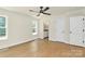 Spacious bedroom featuring wood-look flooring, a ceiling fan, and a view of the en-suite bathroom at 1323 Christopher Cir, Rock Hill, SC 29730