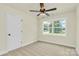 Comfortable bedroom with neutral carpet, a ceiling fan, and a window overlooking the neighborhood at 1323 Christopher Cir, Rock Hill, SC 29730