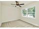 Cozy bedroom with neutral carpet, ceiling fan, and a large window overlooking the backyard at 1323 Christopher Cir, Rock Hill, SC 29730