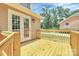 Newly constructed wooden deck leading to French doors of home's exterior, including painted railing at 1323 Christopher Cir, Rock Hill, SC 29730