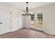 Bright dining room with new flooring, modern light fixture, and patio access at 1323 Christopher Cir, Rock Hill, SC 29730