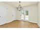 The dining room features wood-look flooring, glass patio doors, and a modern chandelier at 1323 Christopher Cir, Rock Hill, SC 29730