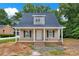 Charming single-Gathering home with covered porch, neutral siding, and black shutters, ready for a new Gathering at 1323 Christopher Cir, Rock Hill, SC 29730