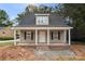 New construction home featuring a covered porch, dormer window, black shutters, and gray siding at 1323 Christopher Cir, Rock Hill, SC 29730