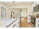 Well-lit kitchen showcasing granite countertops, an island with a sink, and open access into the living room at 1323 Christopher Cir, Rock Hill, SC 29730