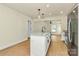 Bright kitchen featuring an island, granite countertops, stainless steel refrigerator, and views into the open concept living area at 1323 Christopher Cir, Rock Hill, SC 29730