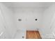 Well-lit laundry room features a sleek shelf and connections for a washer and dryer at 1323 Christopher Cir, Rock Hill, SC 29730