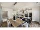 Bright dining area with kitchen and modern chandelier at 134 Judson Ave, Charlotte, NC 28208