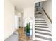 Bright entryway with staircase, wood floors, and large mirror at 134 Judson Ave, Charlotte, NC 28208