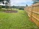 Landscaped backyard with a circular garden at 1535 Rolling Meadow Ln, Gastonia, NC 28054