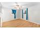 Bright bedroom featuring hardwood floors and teal curtains at 1535 Rolling Meadow Ln, Gastonia, NC 28054