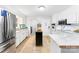 Kitchen features white cabinets, stainless steel appliances, and tile floors at 1535 Rolling Meadow Ln, Gastonia, NC 28054