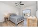 Spacious bedroom with large window, ceiling fan, and wood-look flooring at 194 Tillery Ln, Mount Gilead, NC 27306