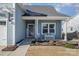 Inviting front porch with white bench, landscaping, and front door at 194 Tillery Ln, Mount Gilead, NC 27306