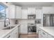 Modern white kitchen with stainless steel appliances and quartz countertops at 194 Tillery Ln, Mount Gilead, NC 27306