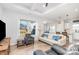 Bright living room with hardwood floors, comfortable seating, and large TV at 194 Tillery Ln, Mount Gilead, NC 27306