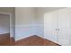 Bedroom with hardwood floors, double door closet and wainscoting at 207 Lee St, Fort Mill, SC 29715