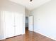 Bedroom with hardwood floors, double door closet and access to another room at 207 Lee St, Fort Mill, SC 29715