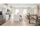 Open concept kitchen and dining area with white cabinets and hardwood floors at 2170 Primm Farms Dr, Charlotte, NC 28216