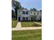 Townhome in neighborhood features a cozy porch and attractive landscaping at 2210 Cranberry Way, Salisbury, NC 28147