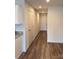 Hallway view with light brown wood flooring, neutral walls, and white doors. Includes storage space at 2210 Cranberry Way, Salisbury, NC 28147
