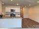 Open-concept kitchen with white cabinets, granite countertops, and stainless steel appliances at 2210 Cranberry Way, Salisbury, NC 28147