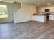 Open living area features durable wood flooring and access to the kitchen at 2210 Cranberry Way, Salisbury, NC 28147