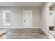 Bright entryway with white door and gray vinyl plank flooring at 2434 Wo Gladden Rd, Chester, SC 29706